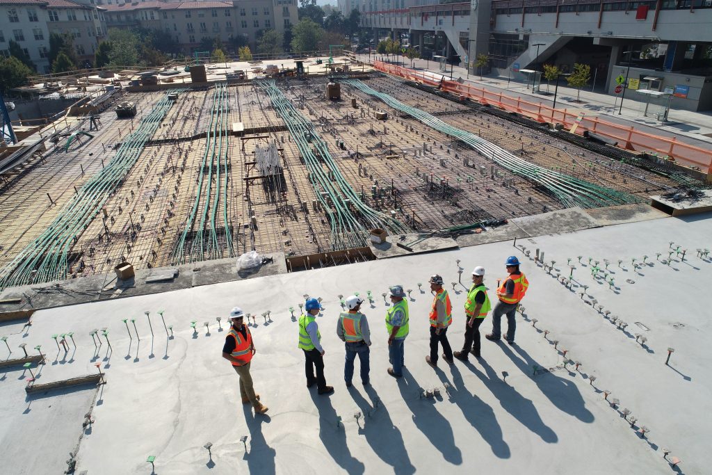Overhead view of workers on a large concrete foundation