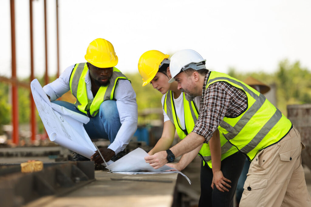 subcontractors looking at a building blueprint